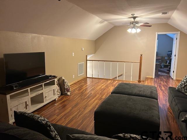 living room featuring vaulted ceiling, wood-type flooring, and ceiling fan