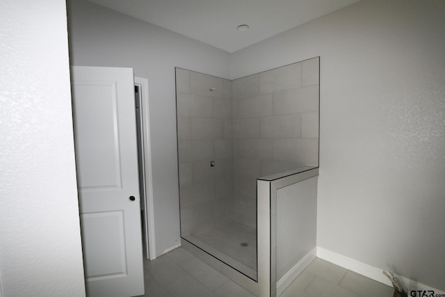 bathroom featuring tiled shower and tile patterned floors