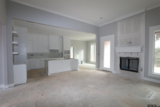 kitchen with white cabinetry, a fireplace, and ornamental molding