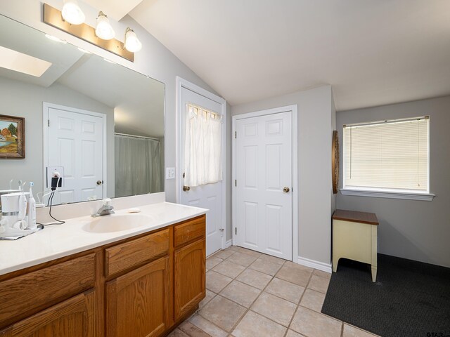 14900 Fm 848, Whitehouse, TX 75791 - full bathroom with a skylight, vanity, tile patterned floors, vaulted ceiling, and a shower with shower curtain