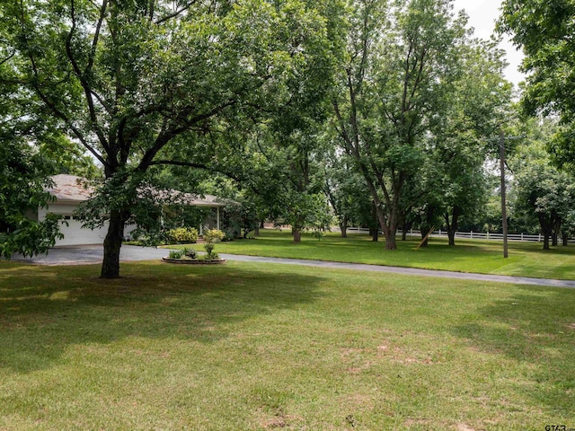14900 Fm 848, Whitehouse, TX 75791 - view of grassy yard featuring an attached garage and driveway