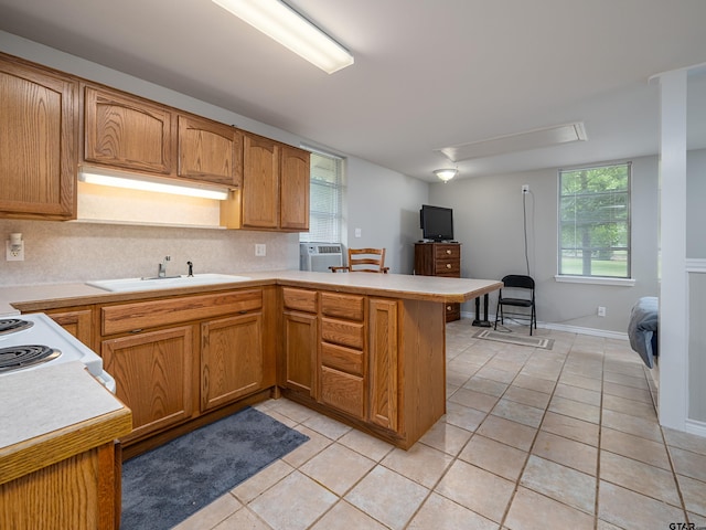 14900 Fm 848, Whitehouse, TX 75791 - kitchen with light countertops, a peninsula, light tile patterned floors, range, and backsplash