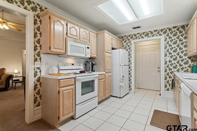 kitchen featuring wallpapered walls, light countertops, visible vents, white appliances, and crown molding