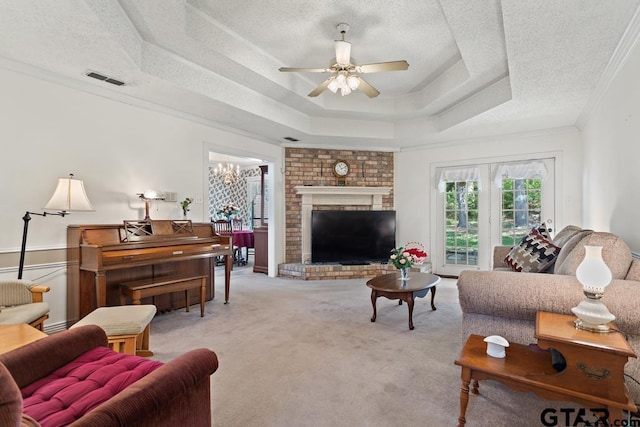 carpeted living room featuring a raised ceiling, visible vents, crown molding, a textured ceiling, and ceiling fan