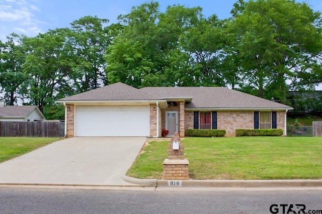 single story home featuring a front lawn, driveway, fence, and a garage