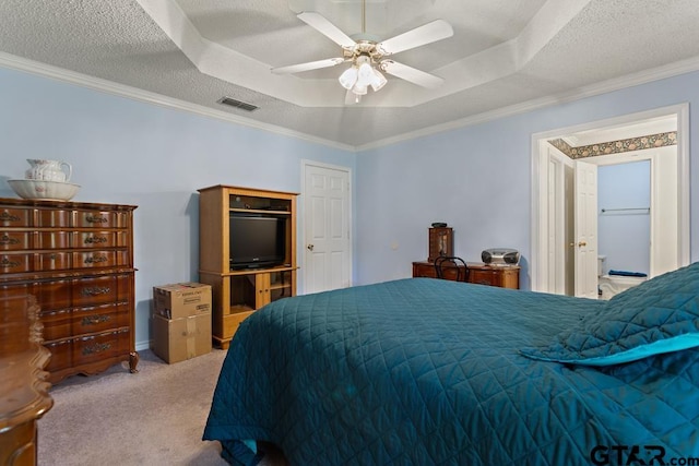bedroom with a raised ceiling, visible vents, a ceiling fan, ornamental molding, and carpet flooring