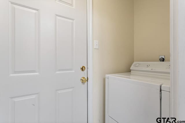 laundry room with washing machine and clothes dryer and laundry area