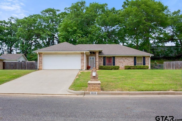ranch-style house with a garage, driveway, a front lawn, and fence