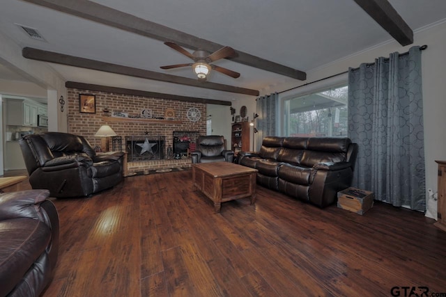 living room featuring dark hardwood / wood-style flooring, a brick fireplace, and beamed ceiling