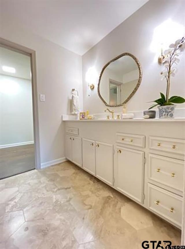 bathroom featuring vanity and baseboards