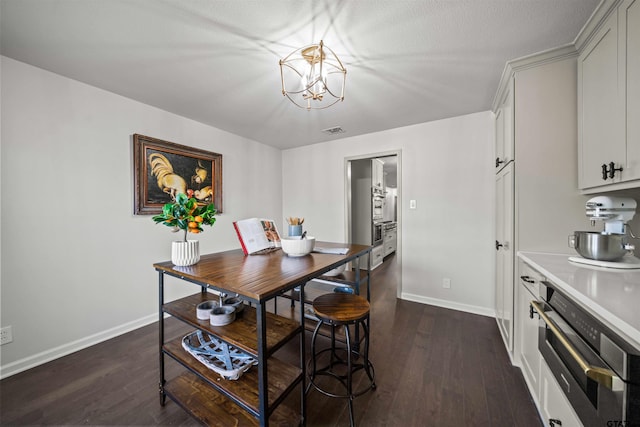 dining room featuring dark wood-type flooring, baseboards, and visible vents