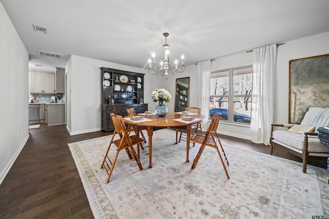 dining room featuring a notable chandelier, visible vents, baseboards, and dark wood-style flooring