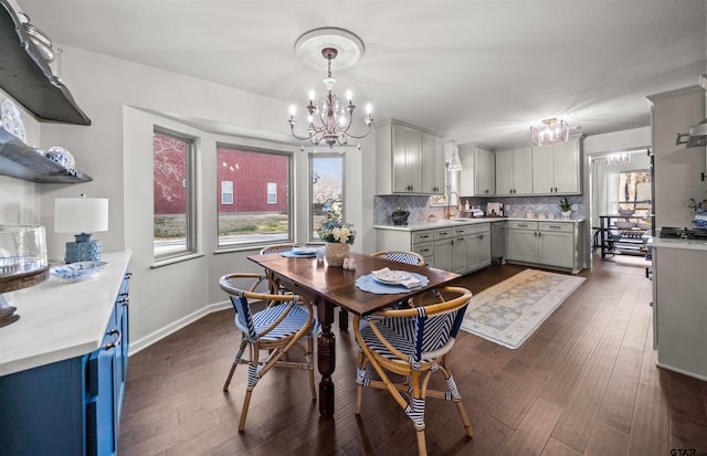 dining space with a healthy amount of sunlight, baseboards, dark wood-type flooring, and an inviting chandelier