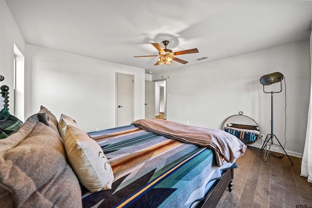 bedroom with visible vents, wood finished floors, and a ceiling fan