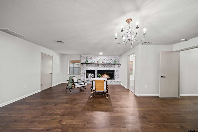 living room with visible vents, a fireplace, and wood finished floors