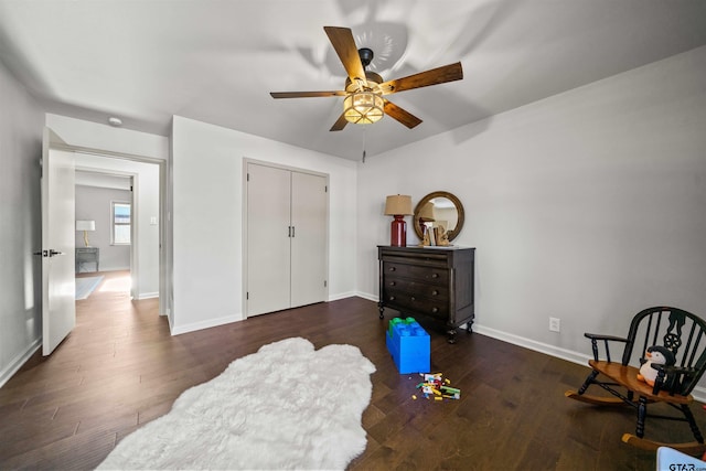 living area with ceiling fan, baseboards, and wood finished floors