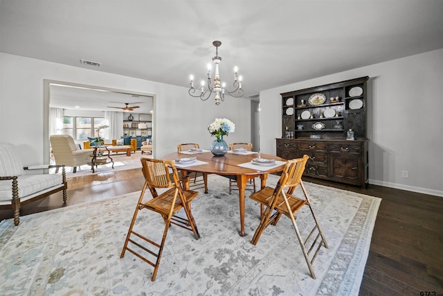 dining room featuring visible vents, ceiling fan with notable chandelier, baseboards, and wood finished floors