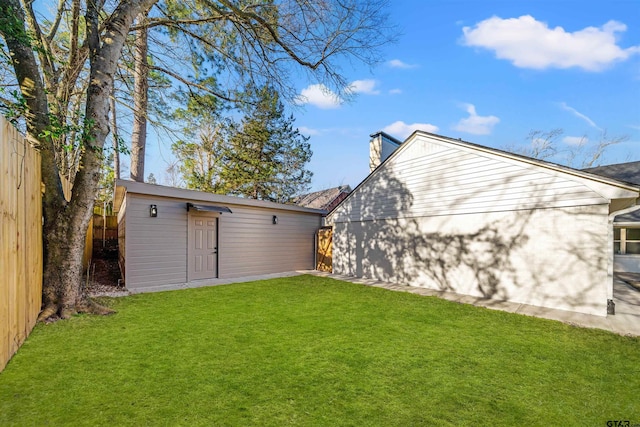 view of yard featuring an outbuilding and a fenced backyard