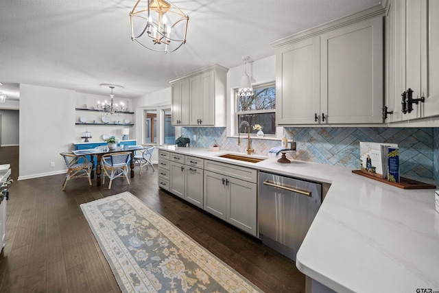 kitchen with a sink, backsplash, dark wood finished floors, an inviting chandelier, and dishwasher