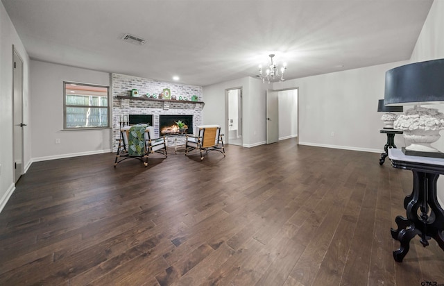 sitting room featuring baseboards, visible vents, dark wood finished floors, a fireplace, and a chandelier