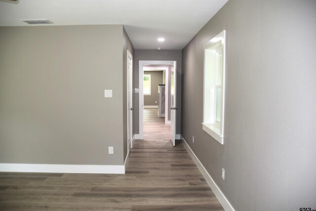 613 Northgate Rd, Hideaway, TX 75771 - hallway with baseboards, visible vents, and wood finished floors