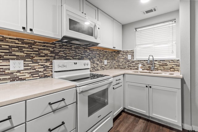 kitchen featuring backsplash, white cabinetry, white appliances, and sink