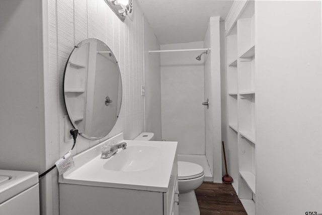 bathroom featuring hardwood / wood-style floors, vanity, toilet, and walk in shower