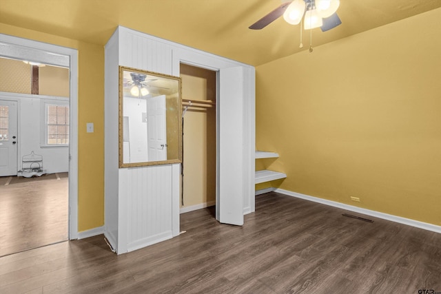 unfurnished bedroom with a closet, dark hardwood / wood-style floors, and ceiling fan