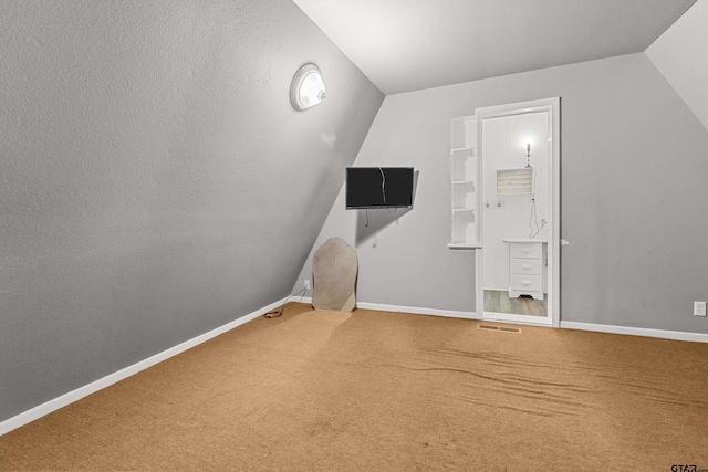 bonus room with carpet floors and lofted ceiling