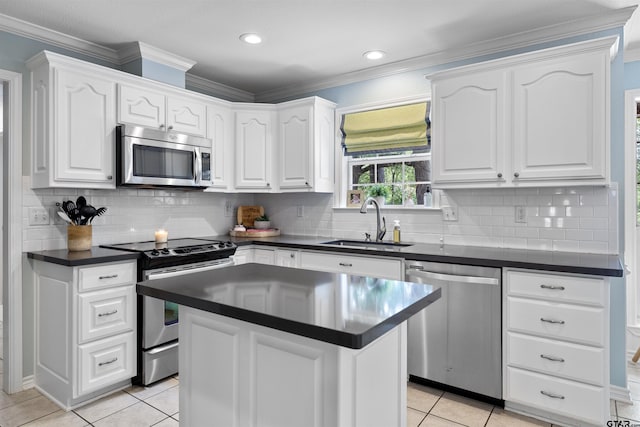 4918 Pine Knl, Tyler, TX 75703 - kitchen featuring stainless steel appliances, dark countertops, a sink, light tile patterned flooring, and white cabinetry