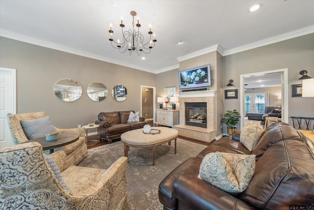 living room with a chandelier, a fireplace, ornamental molding, and hardwood / wood-style flooring