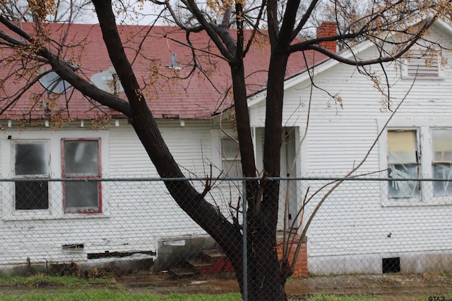 view of side of home featuring crawl space and brick siding