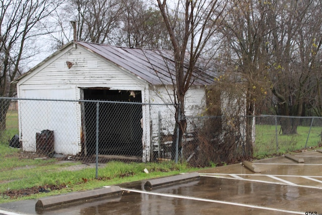 detached garage featuring fence