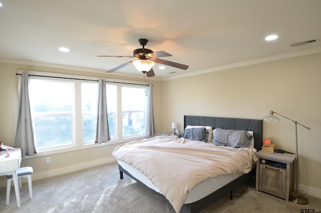 bedroom featuring light colored carpet, ceiling fan, and crown molding