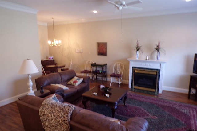 living room with ceiling fan with notable chandelier, hardwood / wood-style flooring, and crown molding