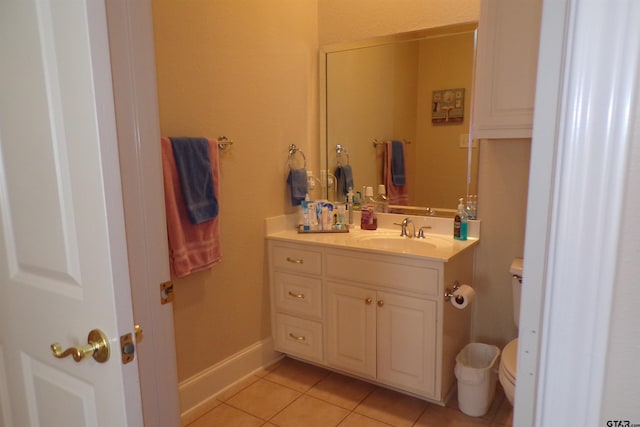 bathroom featuring vanity, tile patterned flooring, and toilet