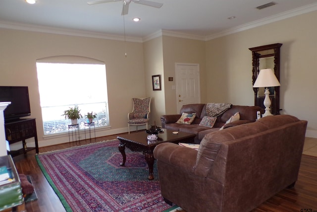 living room featuring ornamental molding, dark wood-type flooring, and ceiling fan