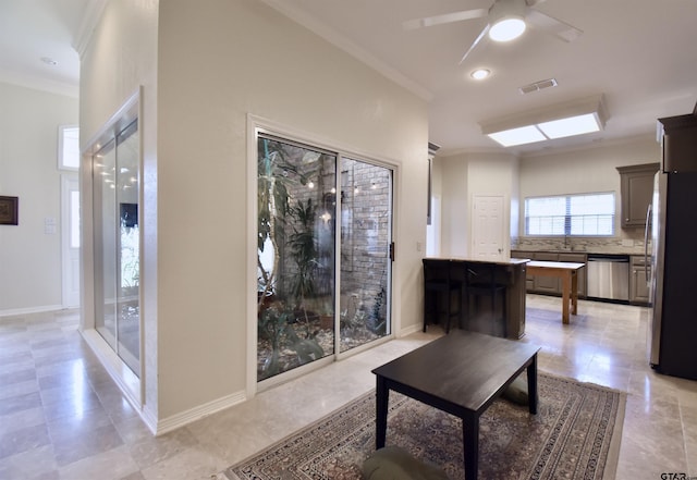 1406 Kingspark Dr, Tyler, TX 75703 - living room featuring ornamental molding, ceiling fan, baseboards, and light tile patterned floors