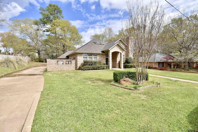 1406 Kingspark Dr, Tyler, TX 75703 - traditional-style home with brick siding, a front lawn, driveway, and a shingled roof