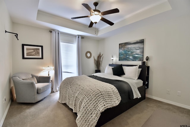 1406 Kingspark Dr, Tyler, TX 75703 - carpeted bedroom with a tray ceiling, baseboards, a ceiling fan, and crown molding