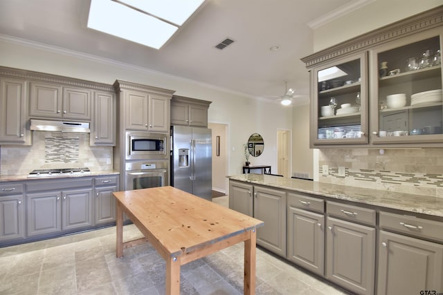 1406 Kingspark Dr, Tyler, TX 75703 - kitchen with stainless steel appliances, gray cabinetry, ornamental molding, and decorative backsplash