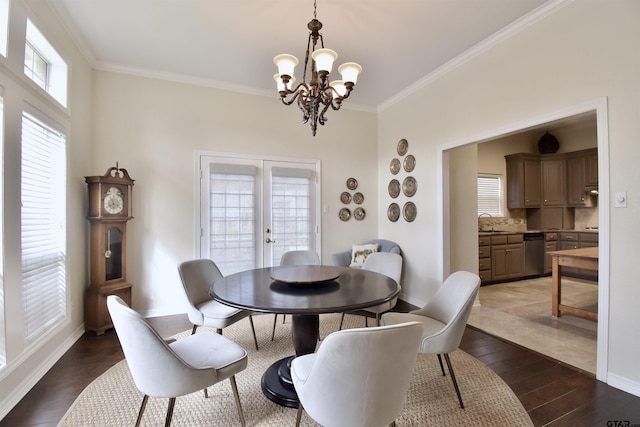 1406 Kingspark Dr, Tyler, TX 75703 - dining room featuring a chandelier, wood finished floors, ornamental molding, baseboards, and french doors