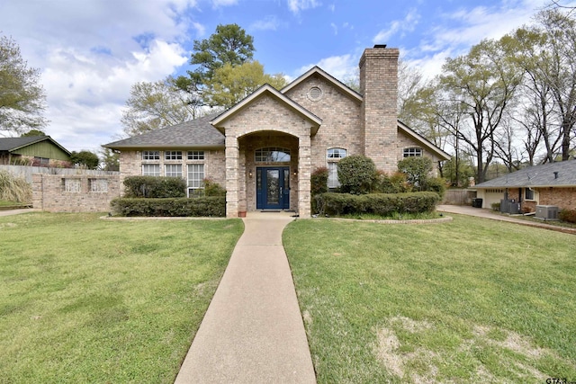 1406 Kingspark Dr, Tyler, TX 75703 - view of front of property featuring brick siding, a chimney, central air condition unit, and a shingled roof