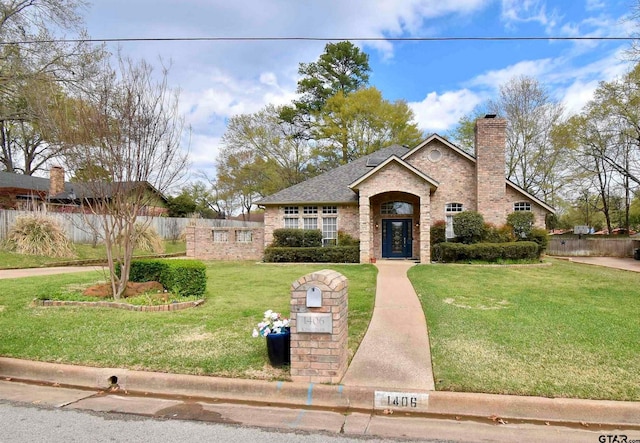 1406 Kingspark Dr, Tyler, TX 75703 - traditional-style house with a chimney, brick siding, and roof with shingles