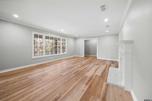 unfurnished living room featuring ornamental molding and light hardwood / wood-style flooring