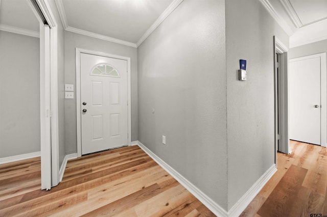 foyer with wood-type flooring and ornamental molding