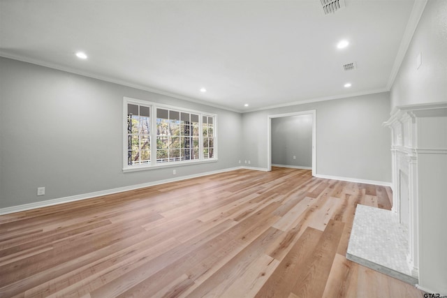 unfurnished living room with light wood-type flooring and crown molding