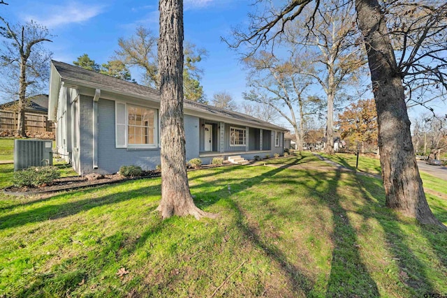 ranch-style house with a front yard and central AC