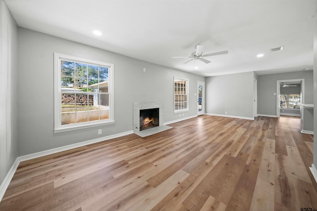 unfurnished living room featuring ceiling fan and light hardwood / wood-style floors