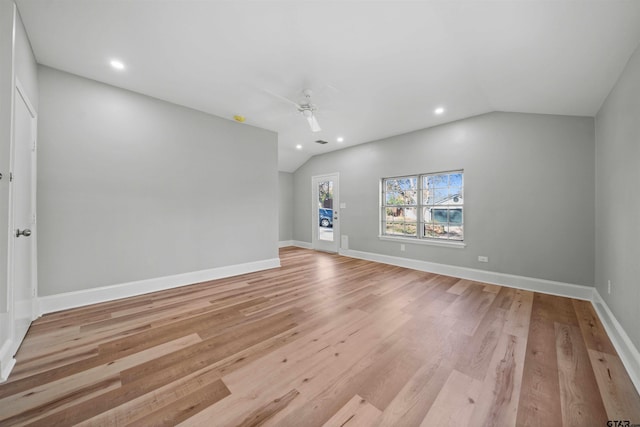 unfurnished living room featuring ceiling fan, light hardwood / wood-style floors, and lofted ceiling